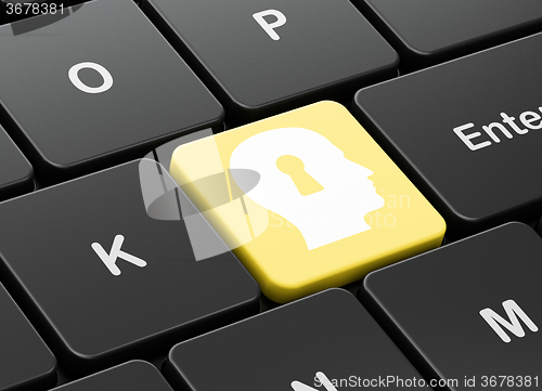 Image of Education concept: Head With Keyhole on computer keyboard background