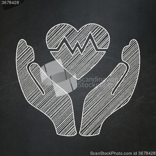 Image of Insurance concept: Heart And Palm on chalkboard background