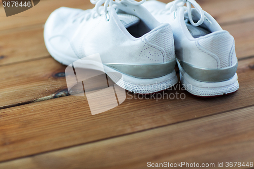 Image of close up of sneakers on wooden floor