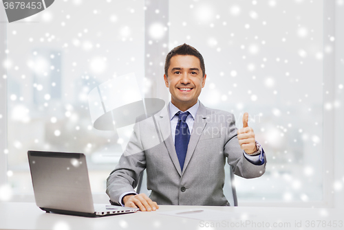 Image of businessman working with laptop in office