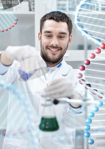 Image of scientist with test tubes making research in lab