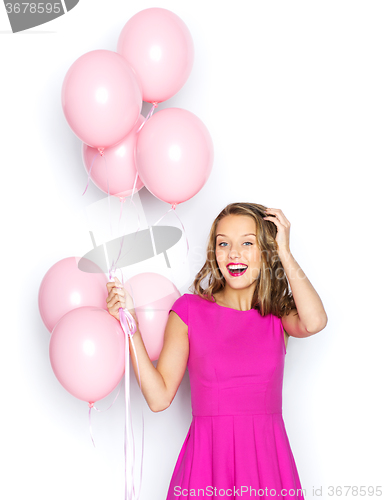 Image of happy young woman or teen girl in pink dress