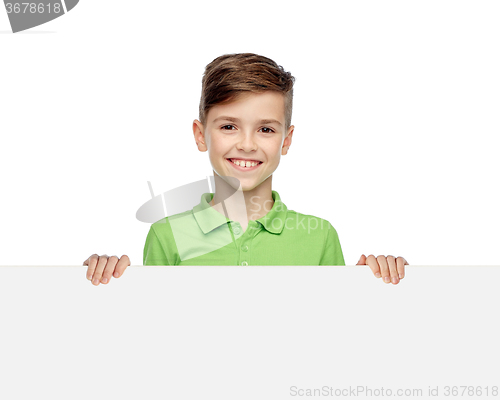 Image of happy boy in t-shirt holding white blank board