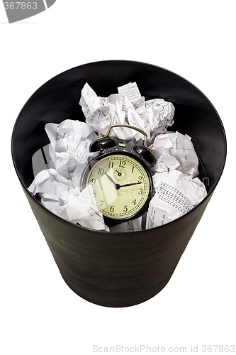 Image of Clock in waste paper basket

