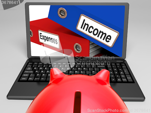 Image of Incomes And Expenses Files On Laptop Showing Earnings