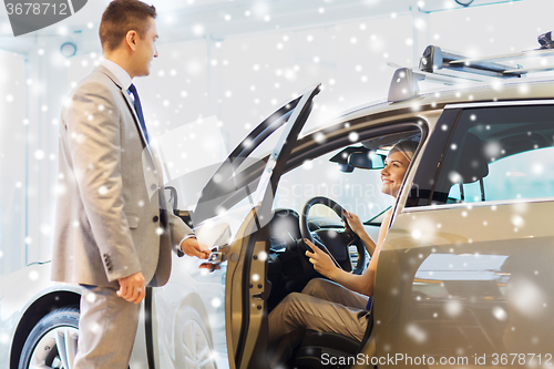 Image of happy woman with car dealer in auto show or salon