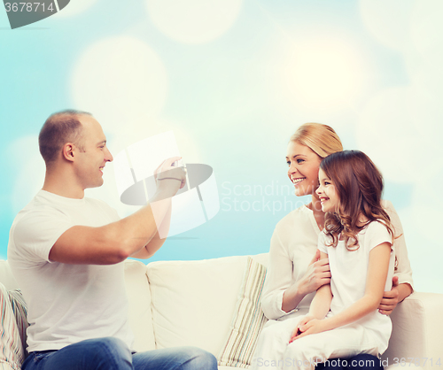 Image of happy family with camera at home