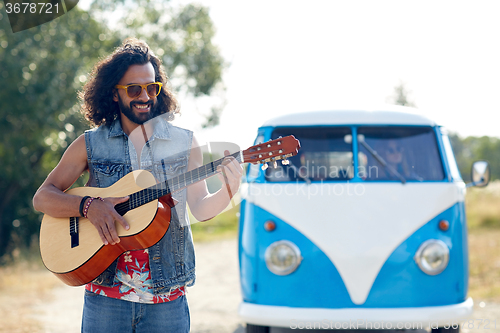 Image of hippie man playing guitar over minivan car outdoor