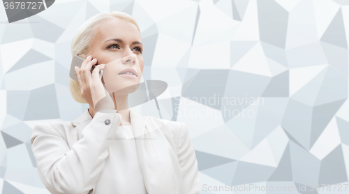 Image of serious businesswoman with smartphone outdoors