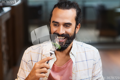 Image of happy man having dinner at restaurant