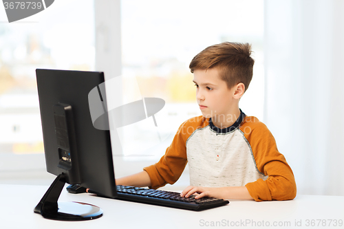 Image of boy with computer at home