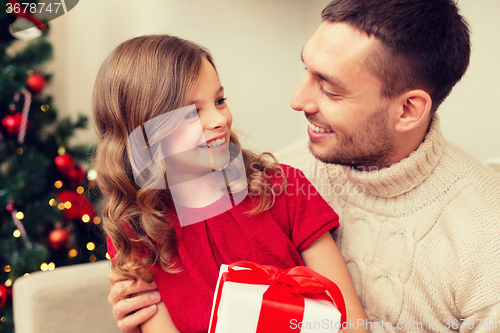 Image of smiling father and daughter looking at each other