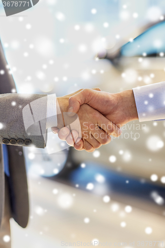 Image of close up of male handshake in auto show or salon