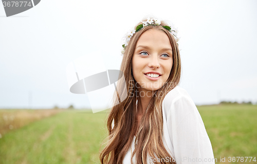 Image of smiling young hippie woman on cereal field