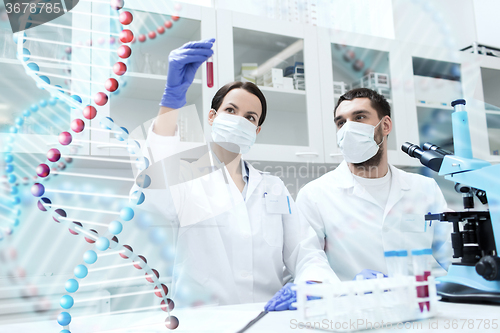 Image of scientists with test tubes making research in lab