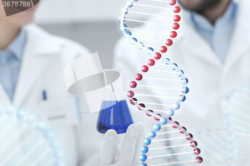 Image of close up of scientists with test tube in lab