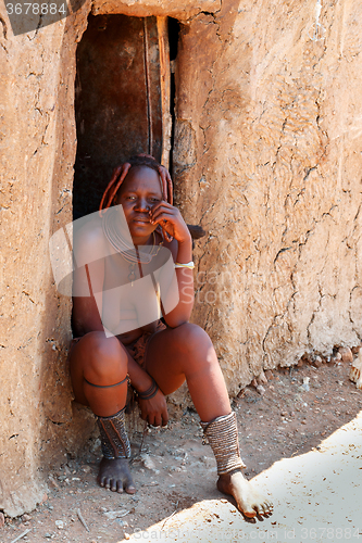 Image of Himba woman with ornaments on the neck in the village