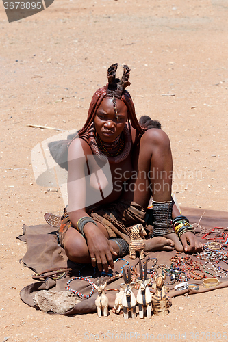 Image of Himba girl with souvenirs for sale in traditional village