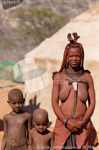 Image of Himba woman with child in the village