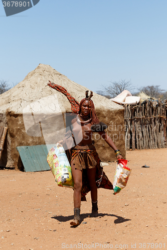 Image of Himba girl with souvenirs for sale in traditional village