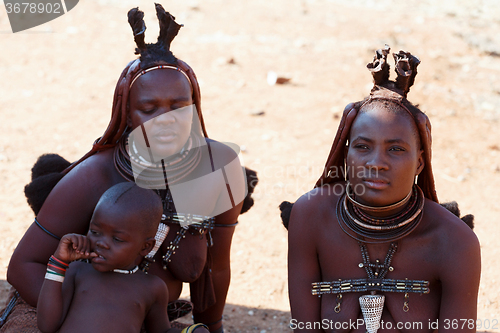 Image of Himba woman with child in the village