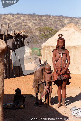 Image of Himba woman with child in the village