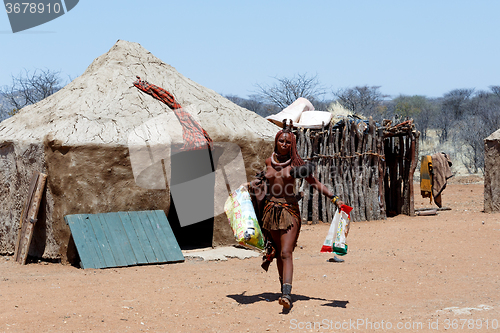 Image of Himba girl with souvenirs for sale in traditional village