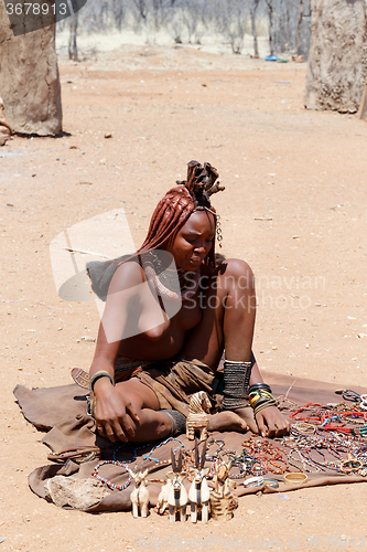 Image of Himba girl with souvenirs for sale in traditional village