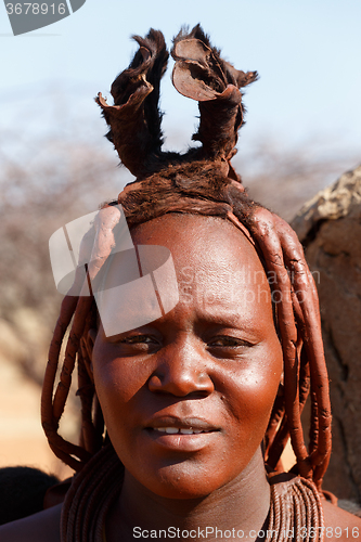 Image of Himba woman with ornaments on the neck in the village