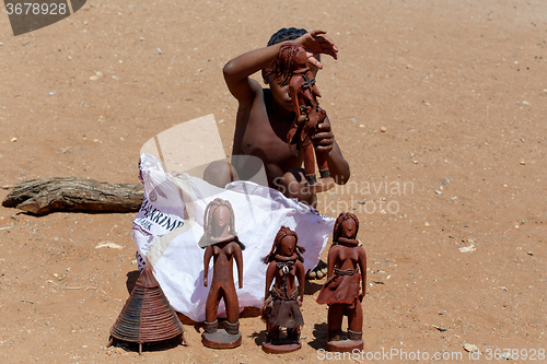 Image of Himba child  with souvenirs for sale in traditional village