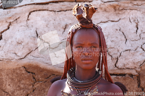 Image of Himba woman with ornaments on the neck in the village