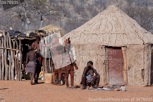 Image of Himba and zemba woman with ornaments on the neck in the village