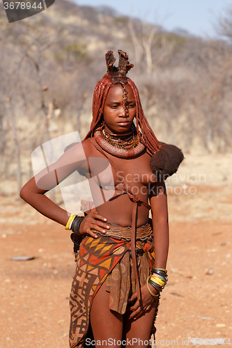 Image of Himba woman with ornaments on the neck in the village