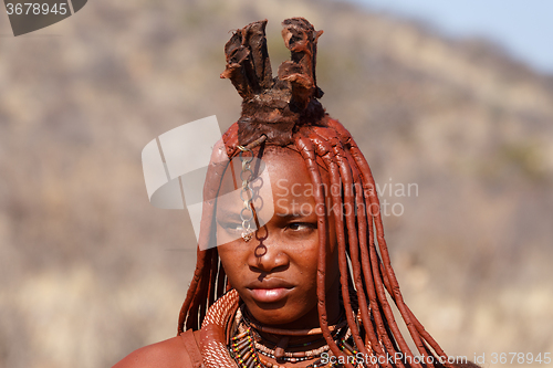 Image of Himba woman with ornaments on the neck in the village