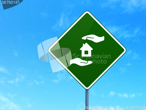 Image of Insurance concept: House And Palm on road sign background