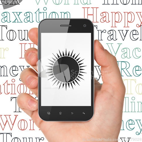 Image of Tourism concept: Hand Holding Smartphone with Sun on display