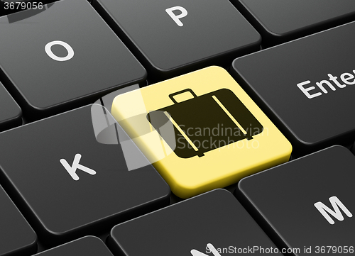 Image of Vacation concept: Bag on computer keyboard background