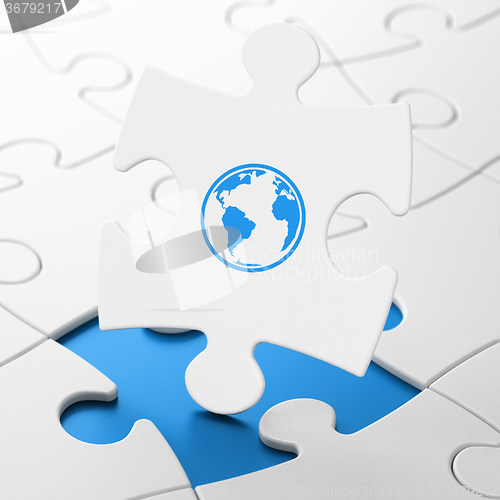 Image of Education concept: Globe on puzzle background