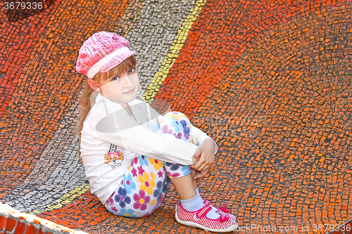 Image of Little girl sitting on the big mosaic panel