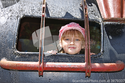 Image of Little girl inside a welded metal attraction