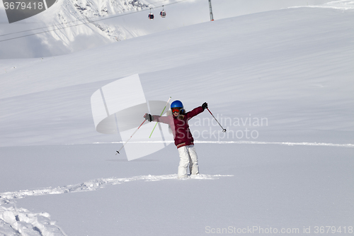 Image of Happy girl on off-piste slope with new fallen snow at nice sun d