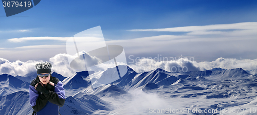 Image of Snowboarder and panoramic view on snowy plateau