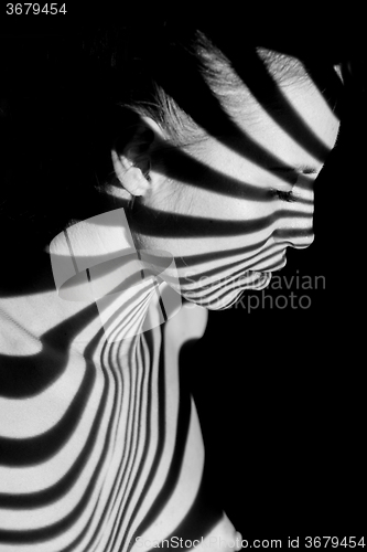 Image of The face of woman with black and white zebra stripes