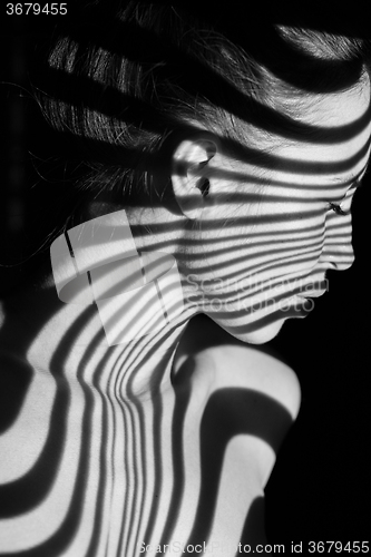 Image of The face of woman with black and white zebra stripes