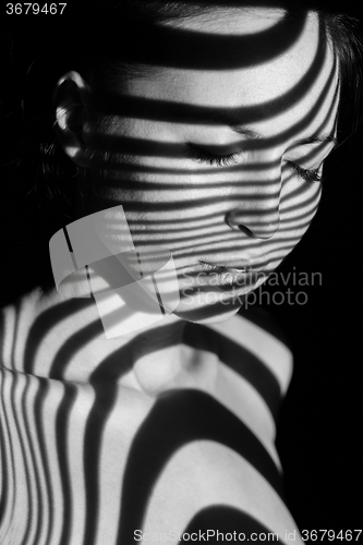 Image of The face of woman with black and white zebra stripes