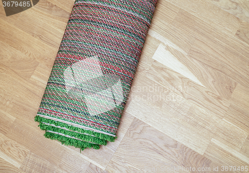 Image of rolled carpet on the floor