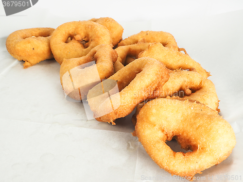 Image of Freshly made doughnuts in a small pile on baking paper