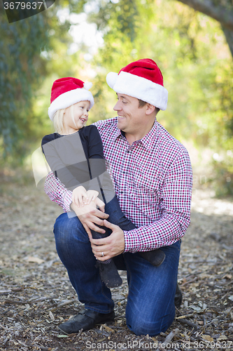 Image of Portrait of Father and Daughter Wearing Santa Hats