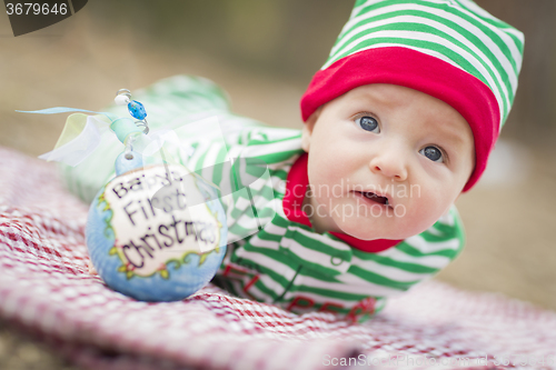 Image of Infant Baby On Blanket With Babys First Christmas Ornament