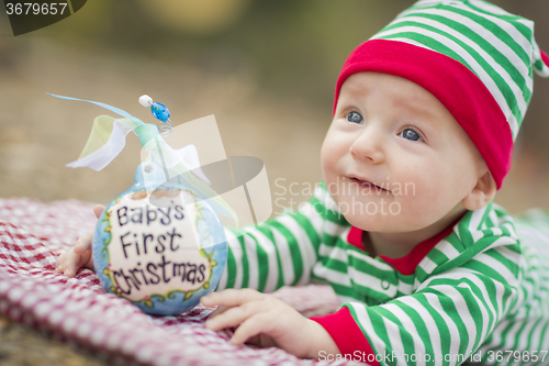 Image of Infant Baby On Blanket With Babys First Christmas Ornament